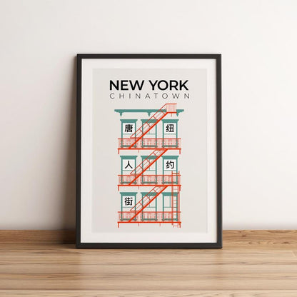 Framed poster of a building with 'New York Chinatown' text on a white wall.